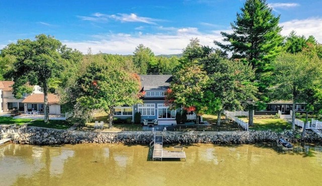 Dog-friendly lakefront home with lake views, firepit, dock, patio, & grill in Ossipee