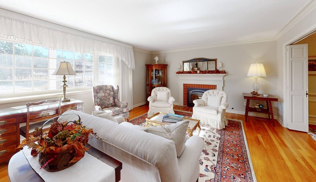 Spacious estate with fenced yard, private pond, outdoor fireplace, & home gym