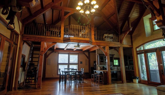 Vaulted beam ceilings, a huge rock fireplace, stream nearby, large campfire area